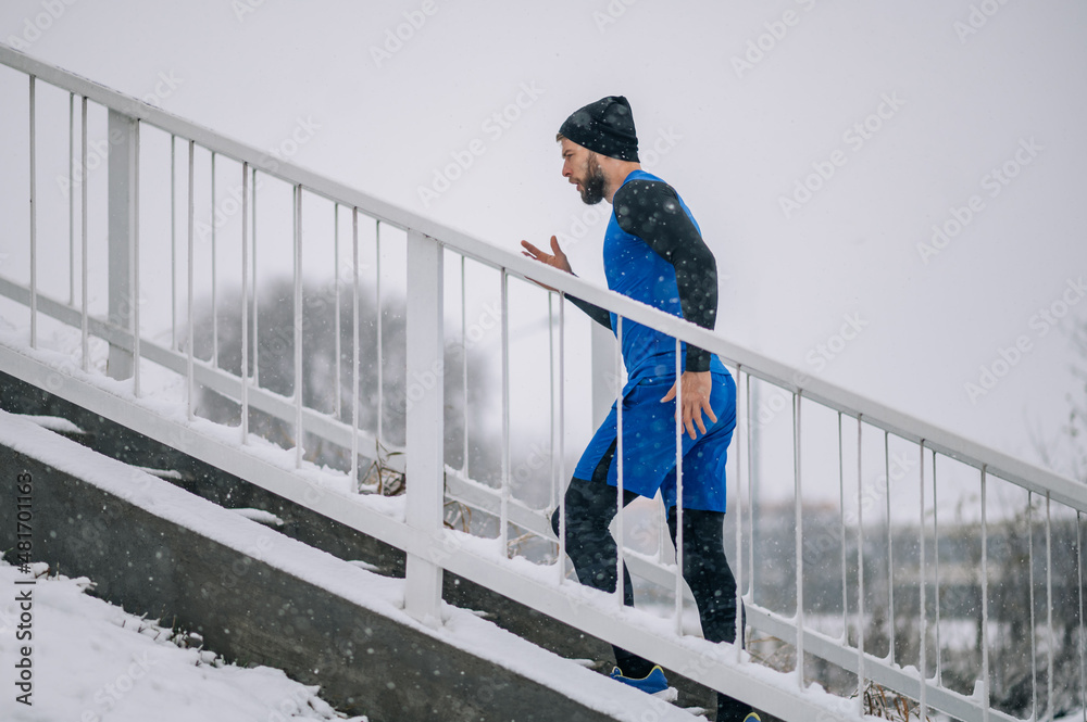 Man running on a stairs on a cold winter day.