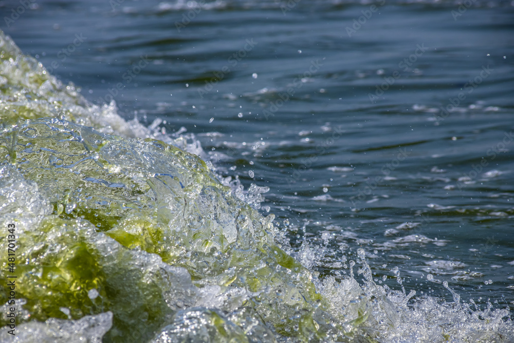 Sea wave with spray and foam near the shore Sea wave with spray and foam near the shore