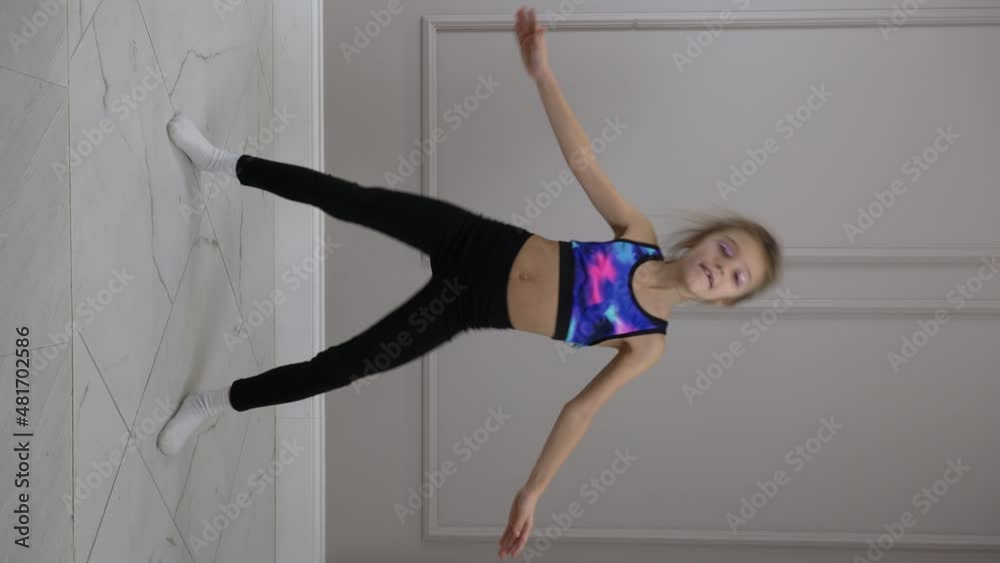 Funny girl dancing. Dancing modern child girl recording trendy dance vertical video for social network. Funny pose. Kid girl moves funny. Vertical video Funny girl dancing. Dancing modern child girl recording trendy dance vertical video for social network. Funny pose. Kid girl moves funny. Vertical video