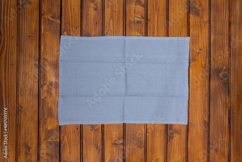 Top view of gray napkin or dish towel on empty wooden table