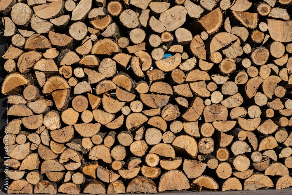 Pile of stacked triangle firewood prepared for fireplace and boiler Pile of stacked triangle firewood prepared for fireplace and boiler
