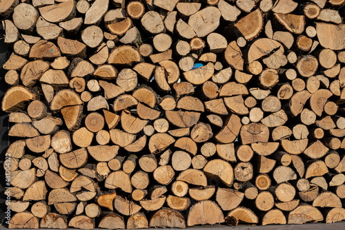 Pile of stacked triangle firewood prepared for fireplace and boiler