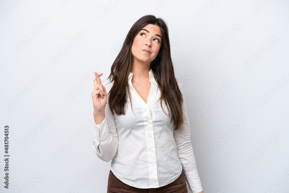 Young Brazilian woman isolated on white background with fingers crossing and wishing the best Young Brazilian woman isolated on white background with fingers crossing and wishing the best