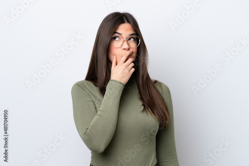 Young Brazilian woman isolated on white background having doubts and with confuse face expression