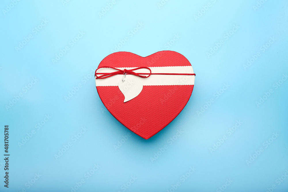 Composition for Valentine's Day February 14. Blue background and heart shaped box of chocolates. Postcard. Flat lay, top view. Composition for Valentine's Day February 14. Blue background and heart shaped box of chocolates. Postcard. Flat lay, top view.