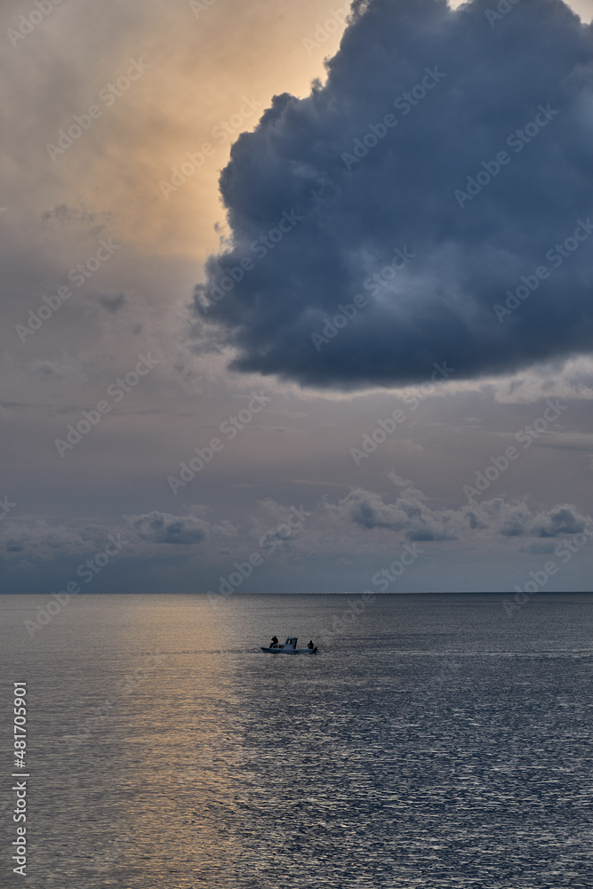 Storm cloud over the small boat in the sea