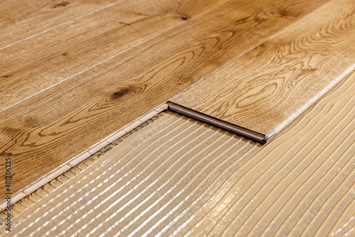 parquet floor installation. wooden planks on flooring glue