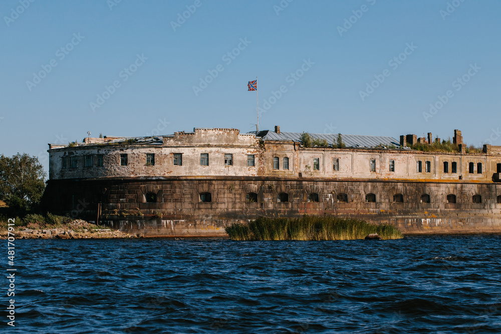View from the water of the oldest fort Kronshlot and the lower sash lighthouse in the waters of the Gulf of Finland in Kronstadt, crown castle, defensive fortress.