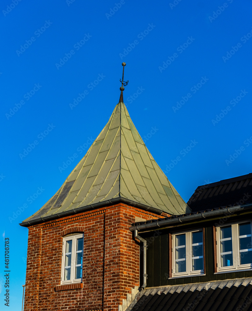 Brick house with pointed copper roof, in norre vorupor denmark