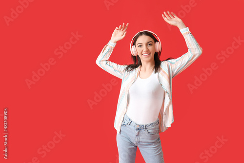 Young woman in pink headpho...