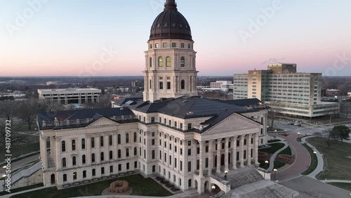 Close up drone footage of Kansas State Capitol building in downtown Topeka with beautiful pink sky at dawn photo