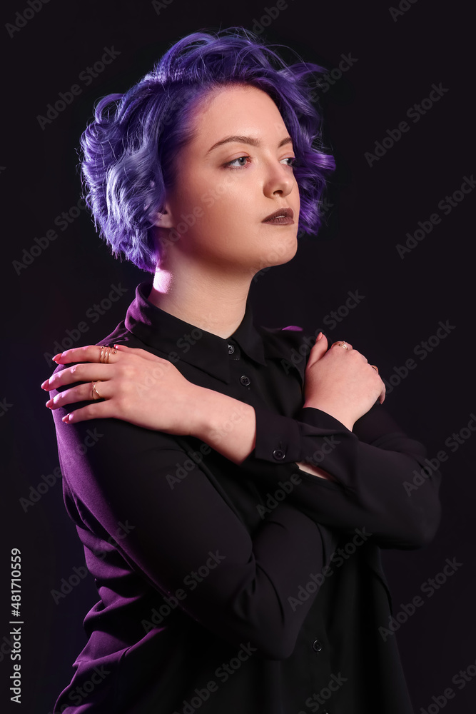 Beautiful young woman with violet hair on black background. Very Peri - color of year 2022 Beautiful young woman with violet hair on black background. Very Peri - color of year 2022