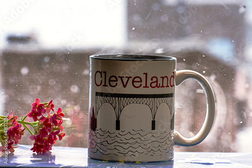 Steaming cup of coffee on a snowy winter day in Cleveland
