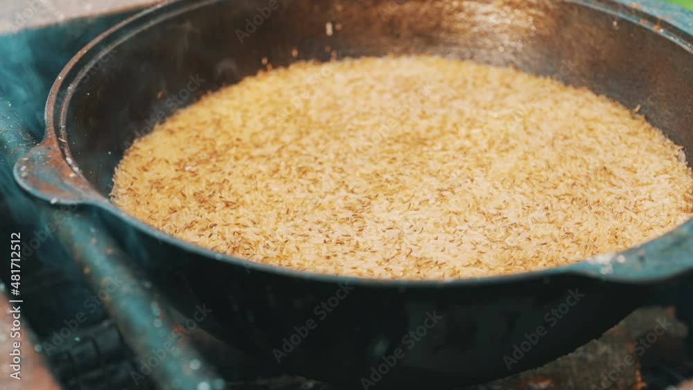 Rice is cooked in cauldron on fire. Step by step cooking of Pilaf. Rice is cooked in cauldron on fire. Step by step cooking of Pilaf.