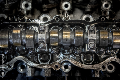 Camshaft on a head removed from the engine in workshop pending repair.