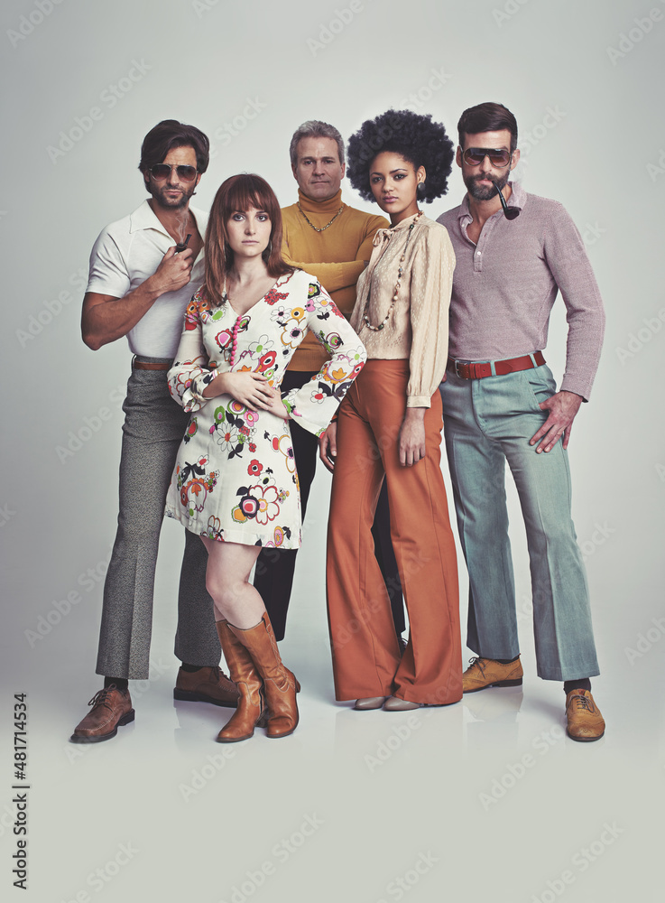 Nothing like some 70s style. A studio shot of a group of people standing  together while clad in retro 70s wear. Stock Photo
