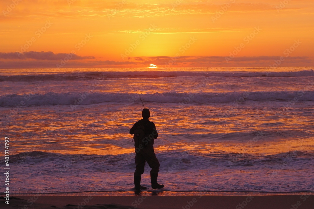 silueta de pescador amateur en la puesta de sol, pesca deportiva, pesca recreativa en la playa