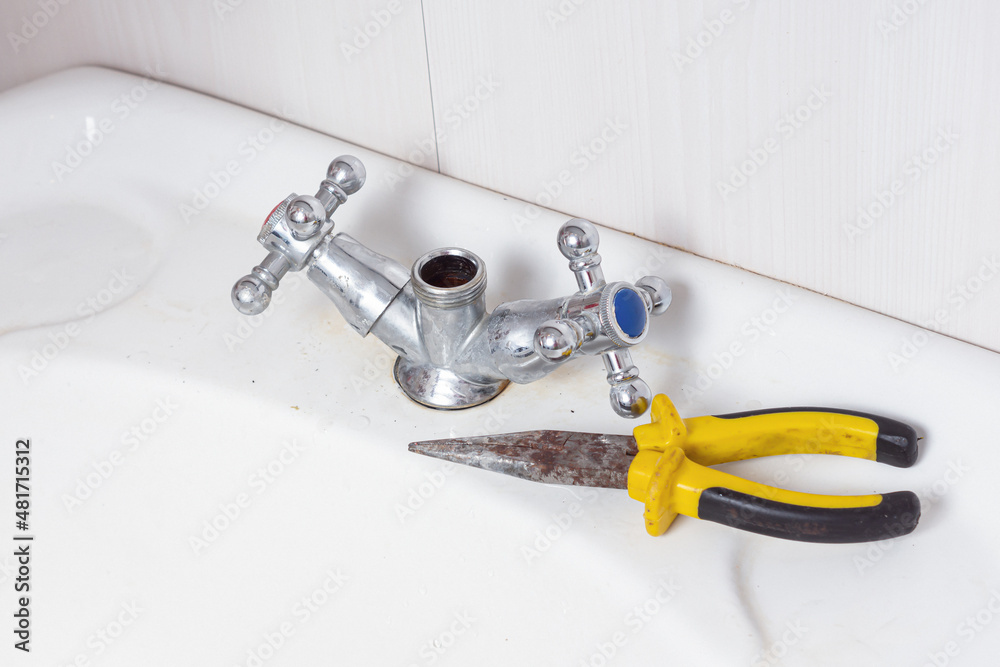 Pliers and faucet in the bathroom. Plumbing repair Pliers and faucet in the bathroom. Plumbing repair