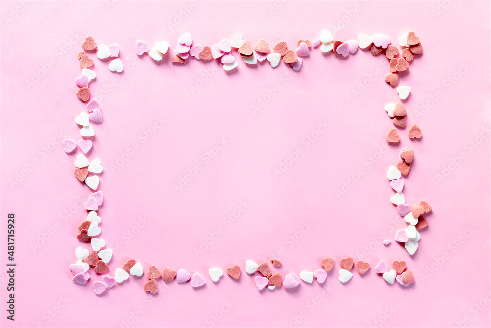 lot of colorful red white and pink heart shaped sprinkles, sweet confetti frame, copy space mock up. pink background for Valentines day, womens day, romance, love pattern