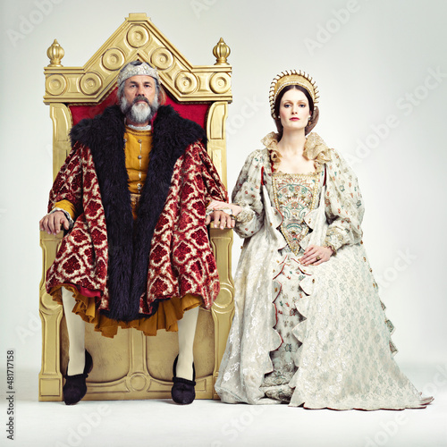 They rule sternly but fairly. Studio shot of a king and queen sitting on thrones.