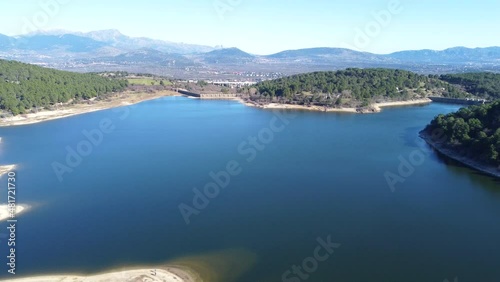 Nice aerial view slowly descending over the Jarosa reservoir in the mountain range of Madrid, located in a beautiful natural environment of the Sierra de Guadarrama, travel, concepts, 4k resolution