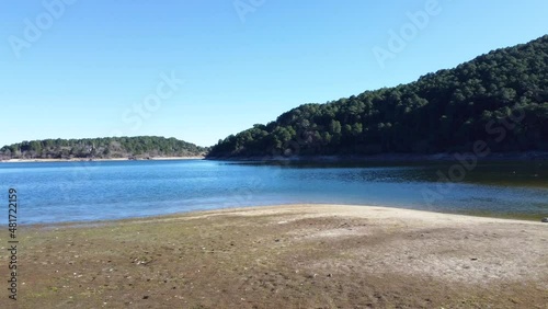 Nice view slowly moving away from the shore of the Jarosa reservoir in Madrid, located in a beautiful natural environment of the Sierra de Guadarrama, travel, concepts, 4k resolution