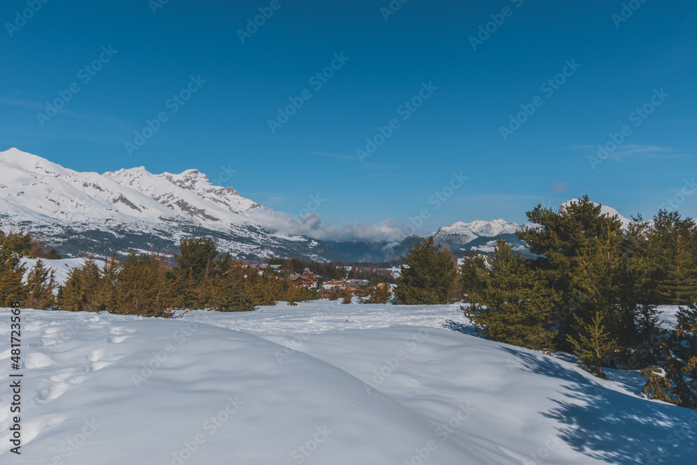 A picturesque landscape view of the French Alps mountains on a cold winter day (La Joue du Loup, Devoluy)