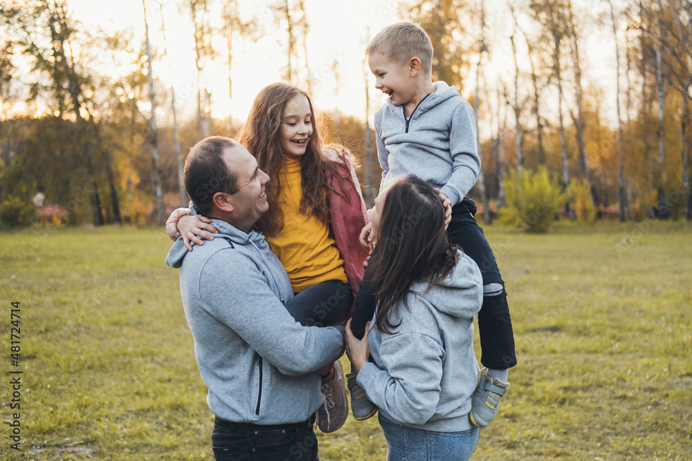 Photo with a caucasian family relaxing in park together. Family time. Photo with a caucasian family relaxing in park together. Family time.