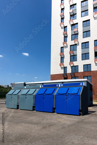 Garbage containers near a residential apartment building for separate waste collection and recycling. Eco friendly concept.