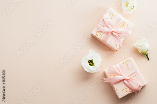 Valentines gifts and rose buds on beige background, top view. Happy Valentines Day greeting card design. © photoguns