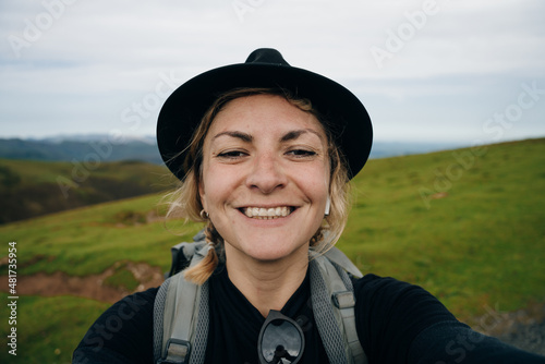 girl traveler pilgrim selfie on Camino de Santiago, to Compostela on the Pyrenees, Navarra, Spain photo