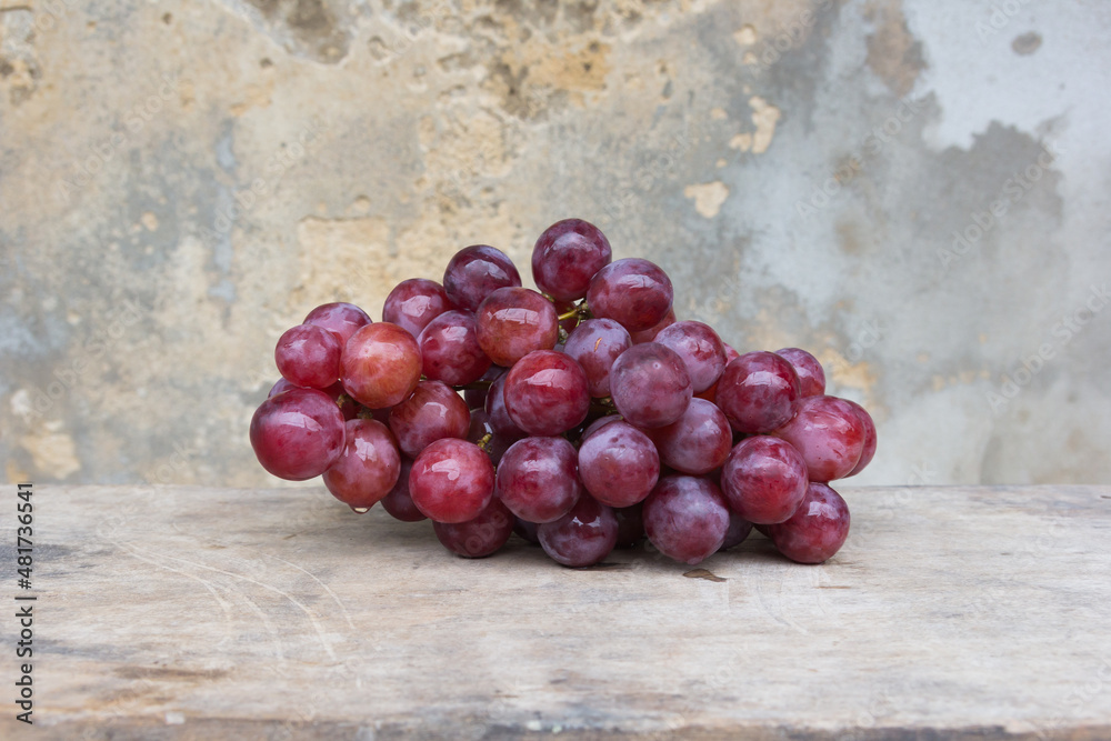 Grape with water drops, old wall background Grape with water drops, old wall background