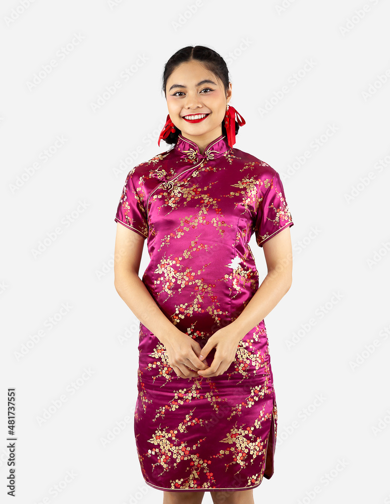 Asian girl smiling in red traditional oriental costume isolated on white background. Chinese new year concept style. Asian girl smiling in red traditional oriental costume isolated on white background. Chinese new year concept style.