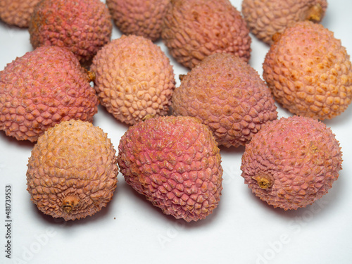 Lychee on the table. Chinese plum on a white background. Ripe fruit from Asia. Delicious  product.