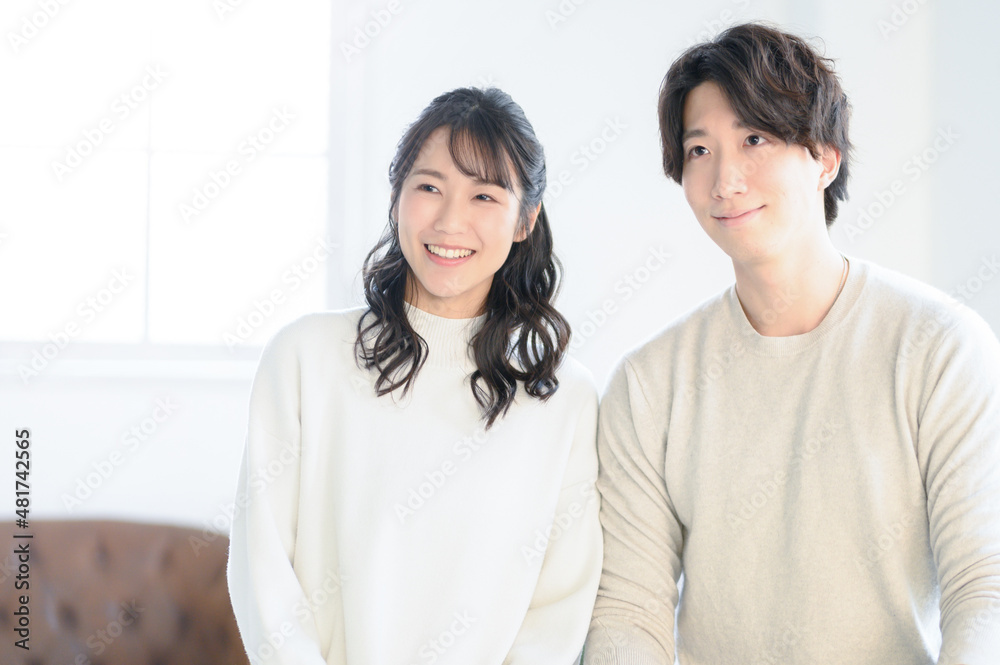 Portrait of a young Asian couple staring at something. Portrait of a young Asian couple staring at something.