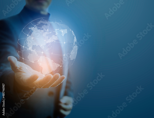Businessman holding a virtual digital globe in his hand in concept of great potentail of handling things or business information. Image composed with right space.