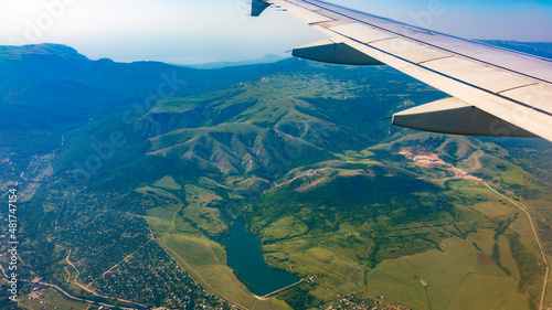 Wallpaper Mural View of airplane wing, blue skies and green land during landing. Airplane window view. Torontodigital.ca