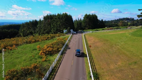 Car driving on a peaceful road towards country club