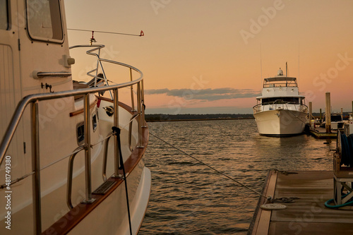 Boats docked in the harbor at sunset photo