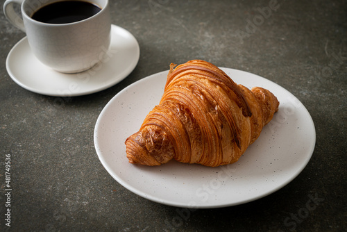 fresh croissant on white plate