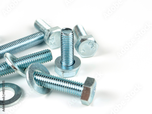 metal bolts and round washers close-up on a white background. copy space