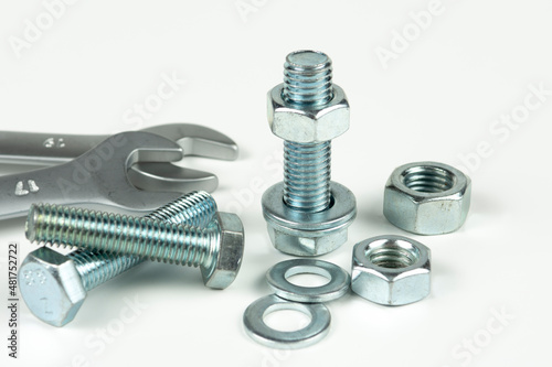 New repair tool, bolts and nuts close-up on a white background. Tool for connecting a threaded connection by tightening bolt nuts