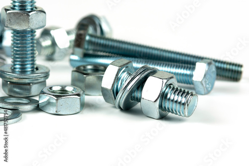 metal bolts and nuts with round washers close-up on a white background. copy space