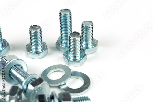 metal bolts and nuts with round washers close-up on a white background. copy space
