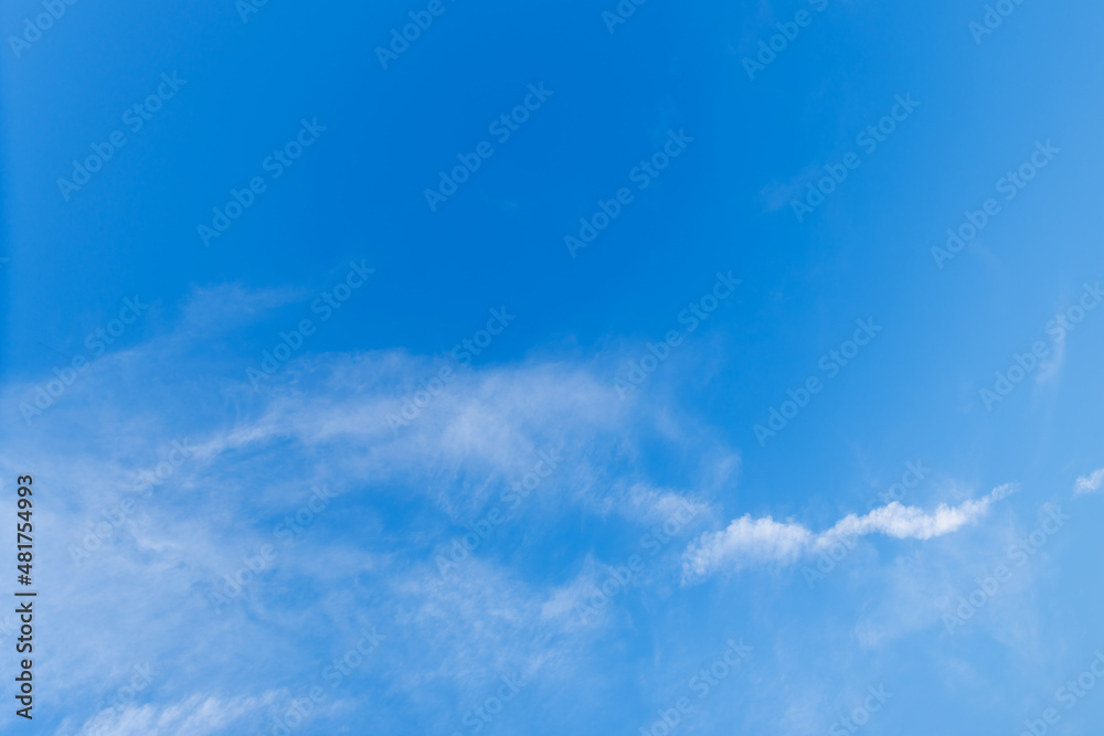 Beautiful clear blue high sky with light fluffy clouds far away on wonderful sunny bright day of summer holiday