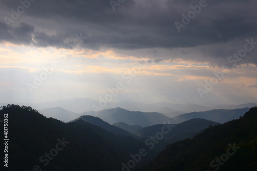 heavenly light and silhouette layers of mountain and cloudy with copy space , background © Nikkiz Studio
