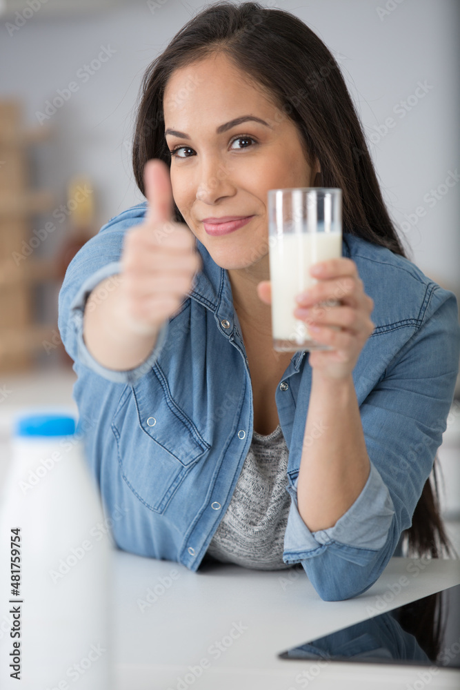 beautiful happy young woman driking a glass of milk beautiful happy young woman driking a glass of milk