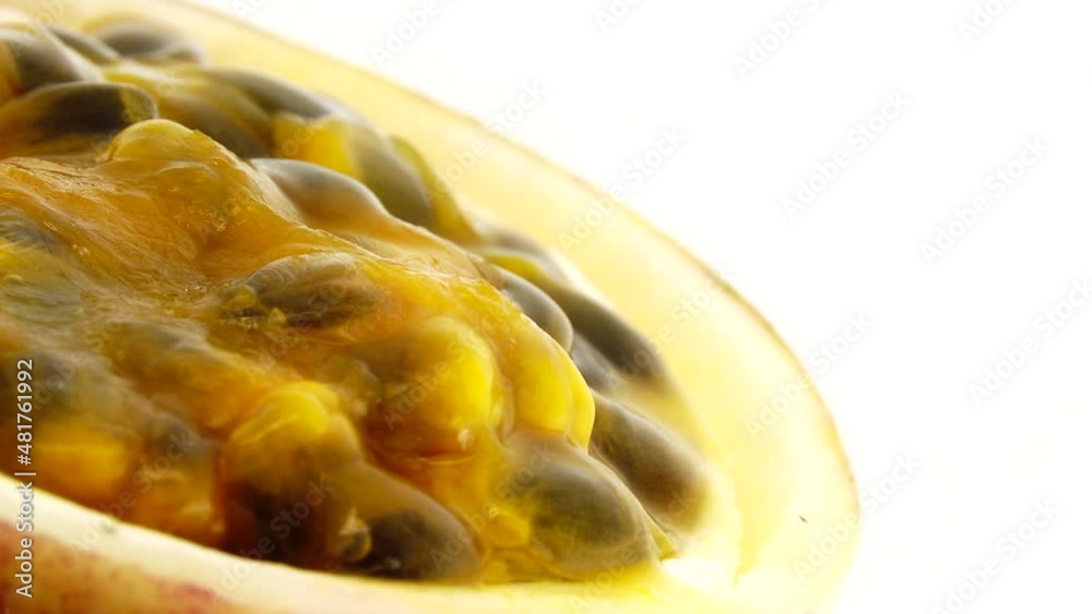 4K cross-section of a puple passion fruit Macro shot of sliced fresh exotic passion fruit fruit rotating isolated on white background 4K cross-section of a puple passion fruit Macro shot of sliced fresh exotic passion fruit fruit rotating isolated on white background