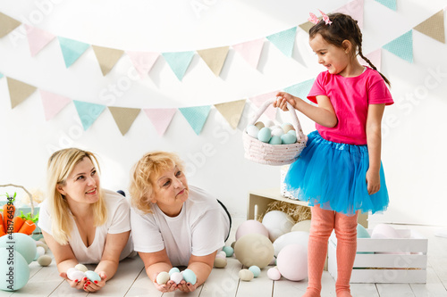 happy family with easter eggs. Happy llittle girl and grandmother with Easter eggs photo