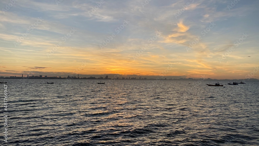Obraz premium Beautiful sunset over the sea or ocean, bright and soft colors, magic light, small clouds in the sky